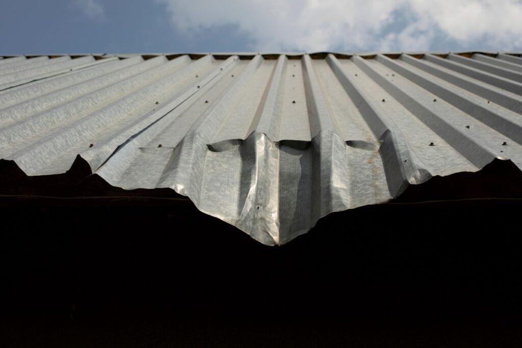 damaged metal roof that needs a repair
