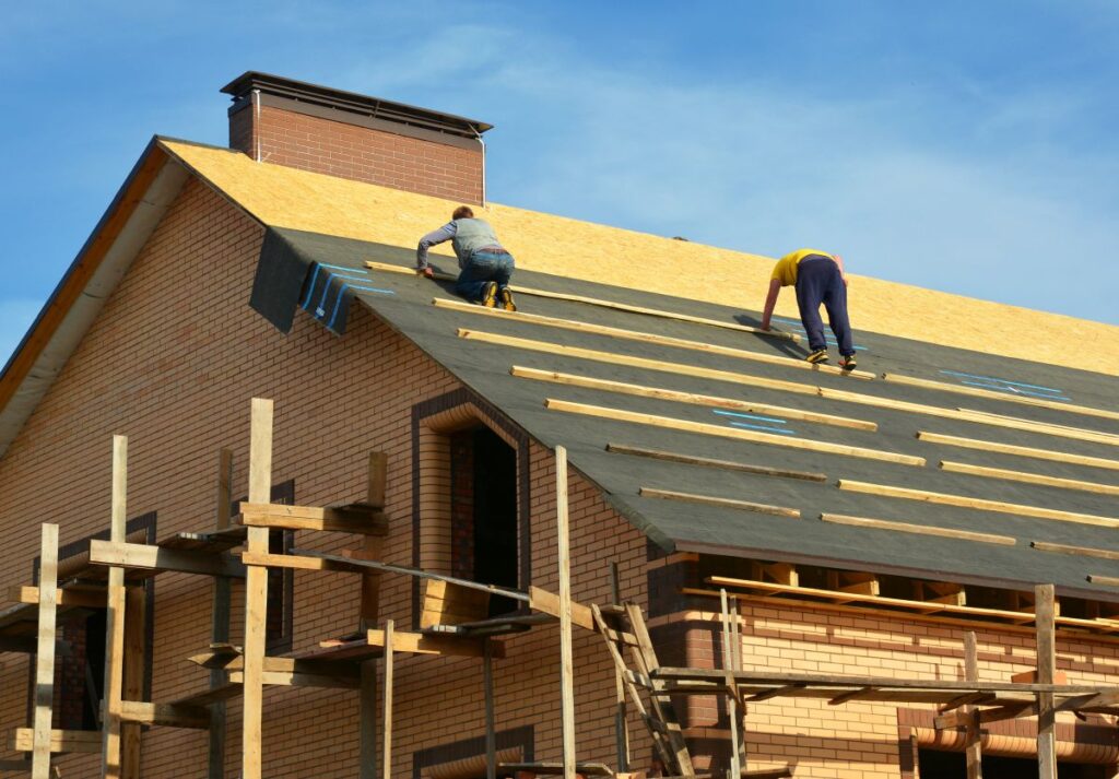 Roofing contractors are installing underlayment