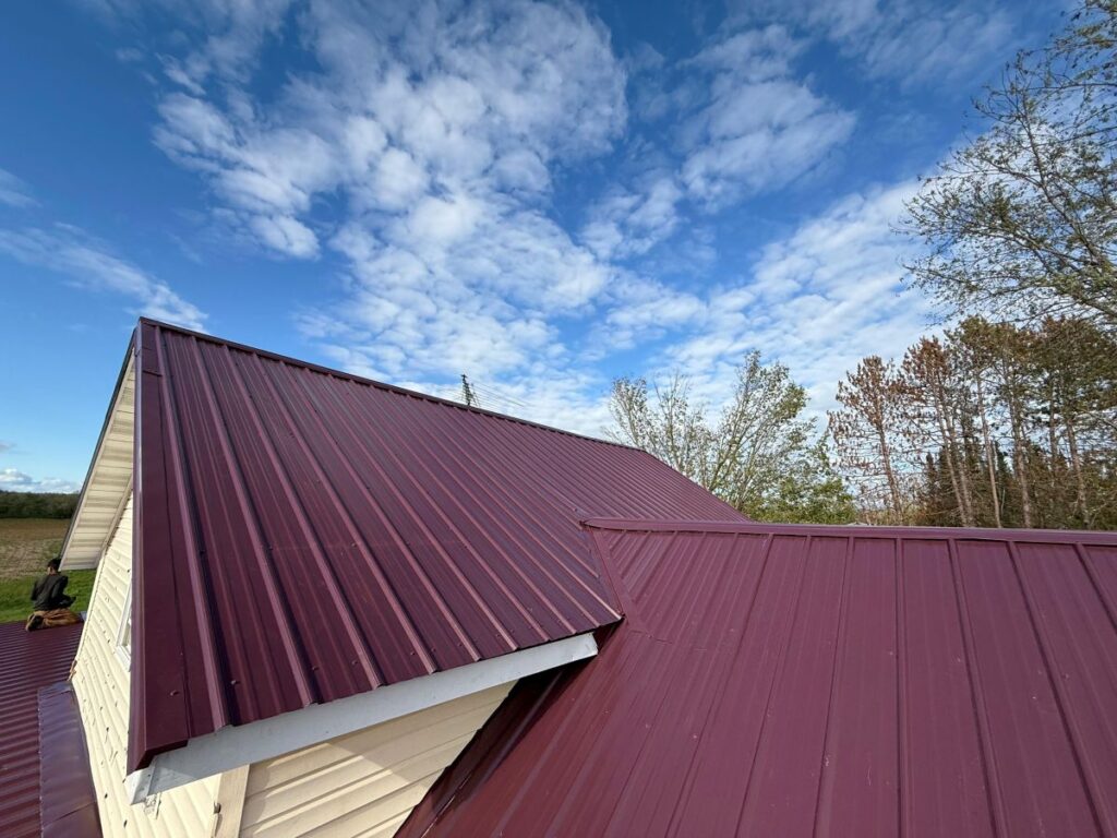 Red metal roof panels installed by Lauren Exteriors