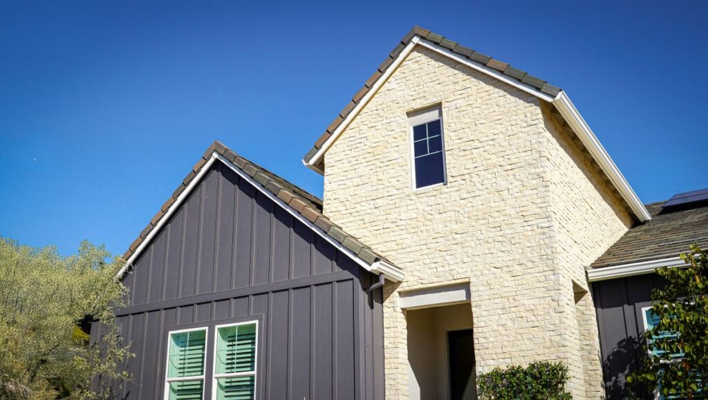 Top of a two toned house. Stone and vinyl Board and Batten
