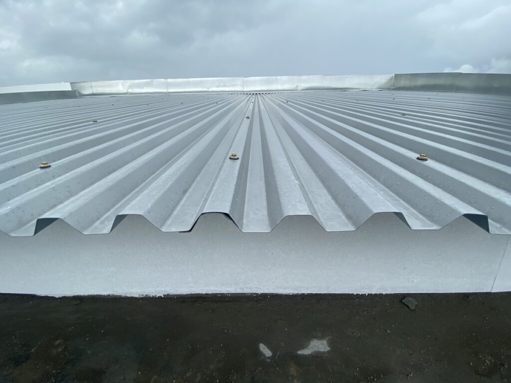 Close up of a corrugated metal deck roof system just installed on a building