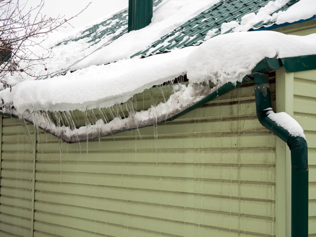 emergency roof repair Drainage system destroyed by snow that slipped from the roof without snow retainers