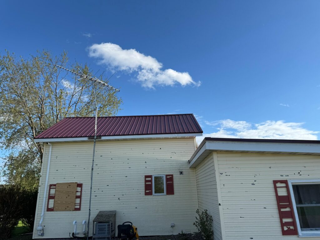 siding repair yellow siding damaged red shingles roof