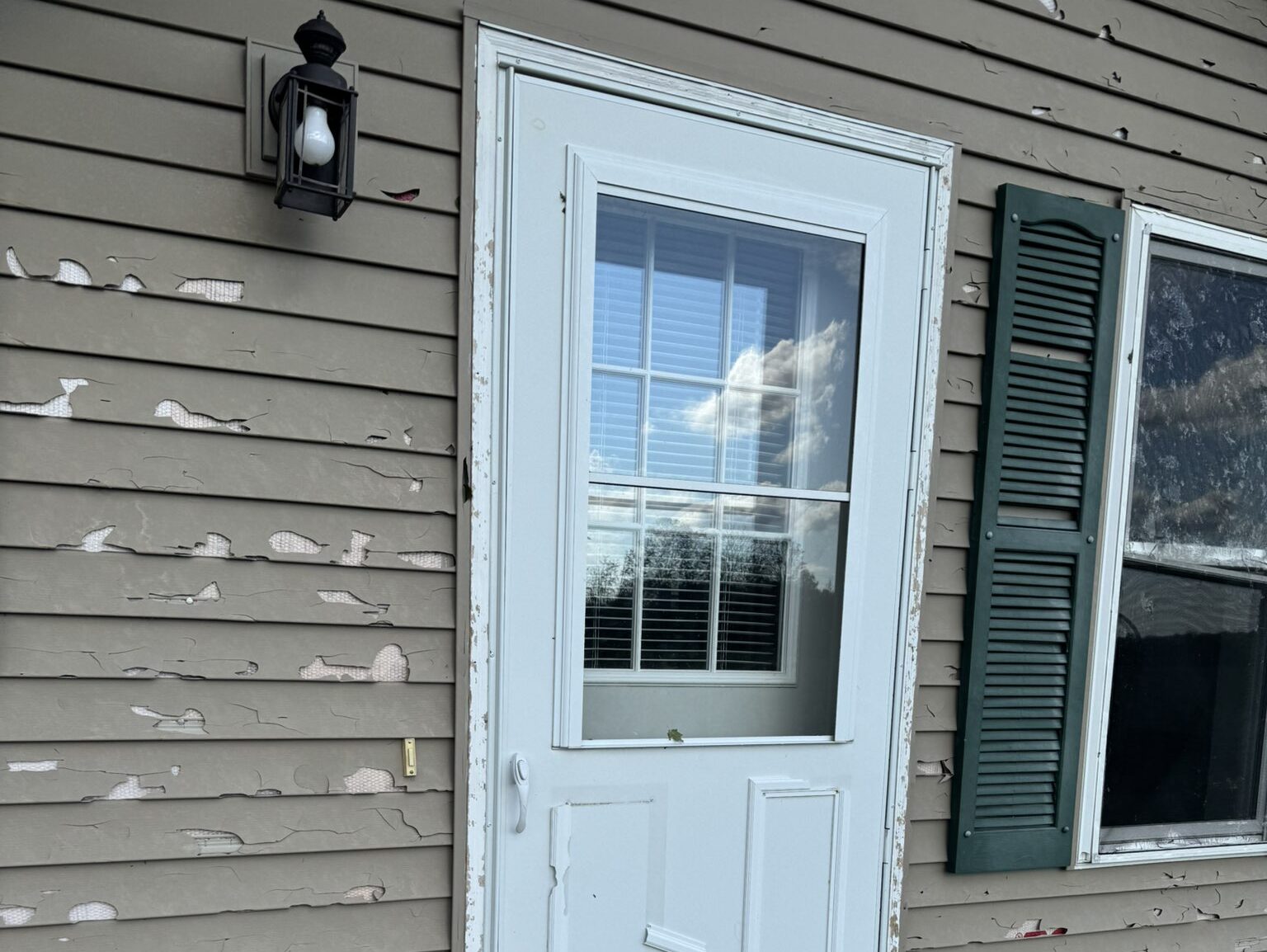 siding repair damaged siding and white door