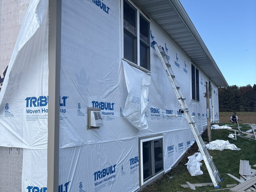 siding replacement cost ladder and paper on the wall