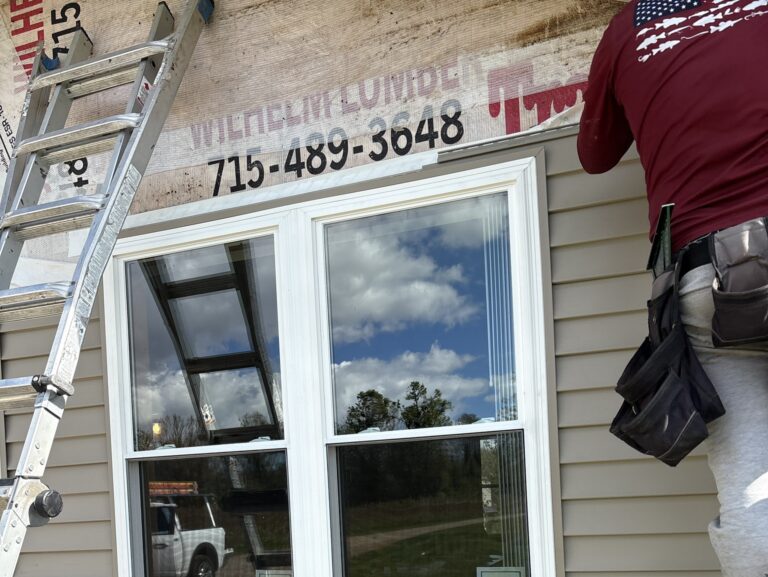 siding replacement cost worker replacing damaged siding