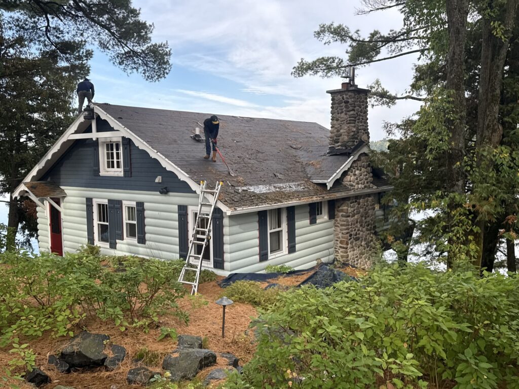 emergency roof repair workers removing shingles form roof